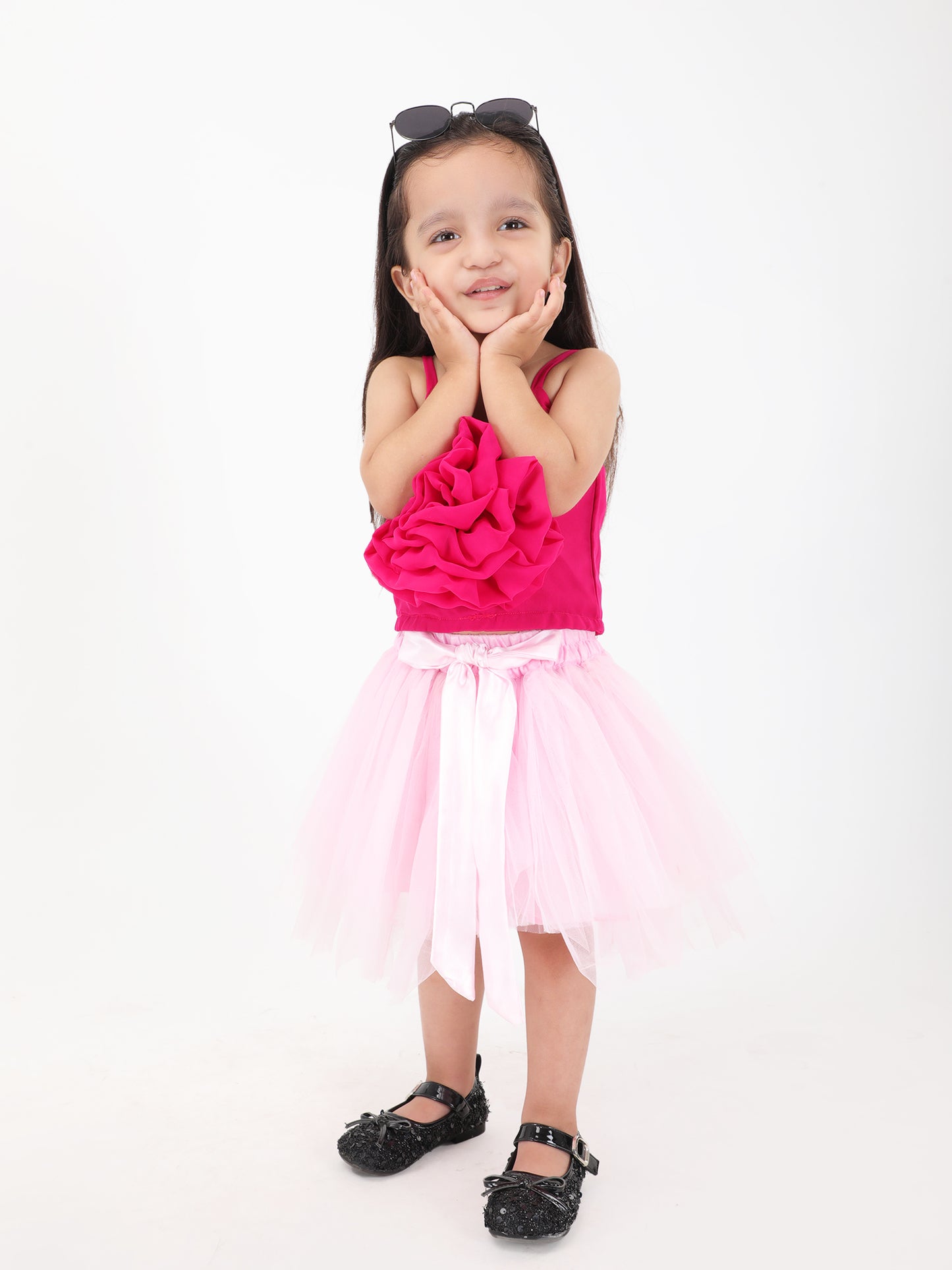 Handcrafted girls festive skirt and top outfit in pink – front view