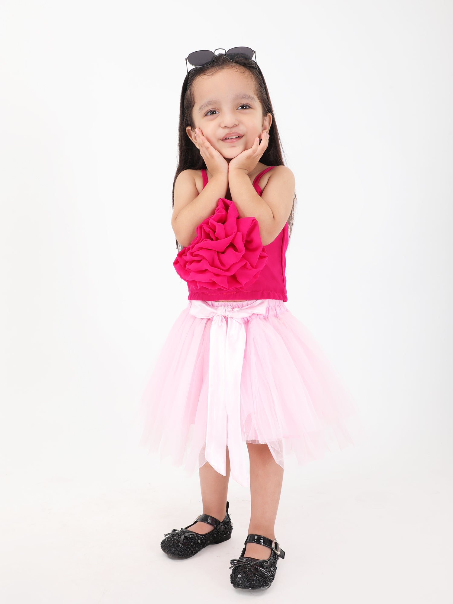 Handcrafted girls festive skirt and top outfit in pink – front view